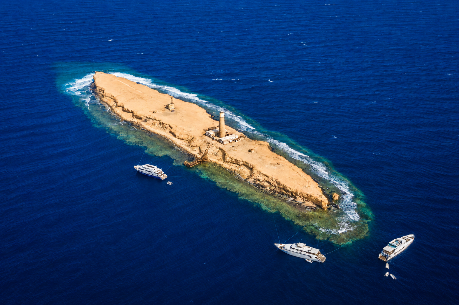 Big Brother seen from above, with the lighthouse and the fringing reef