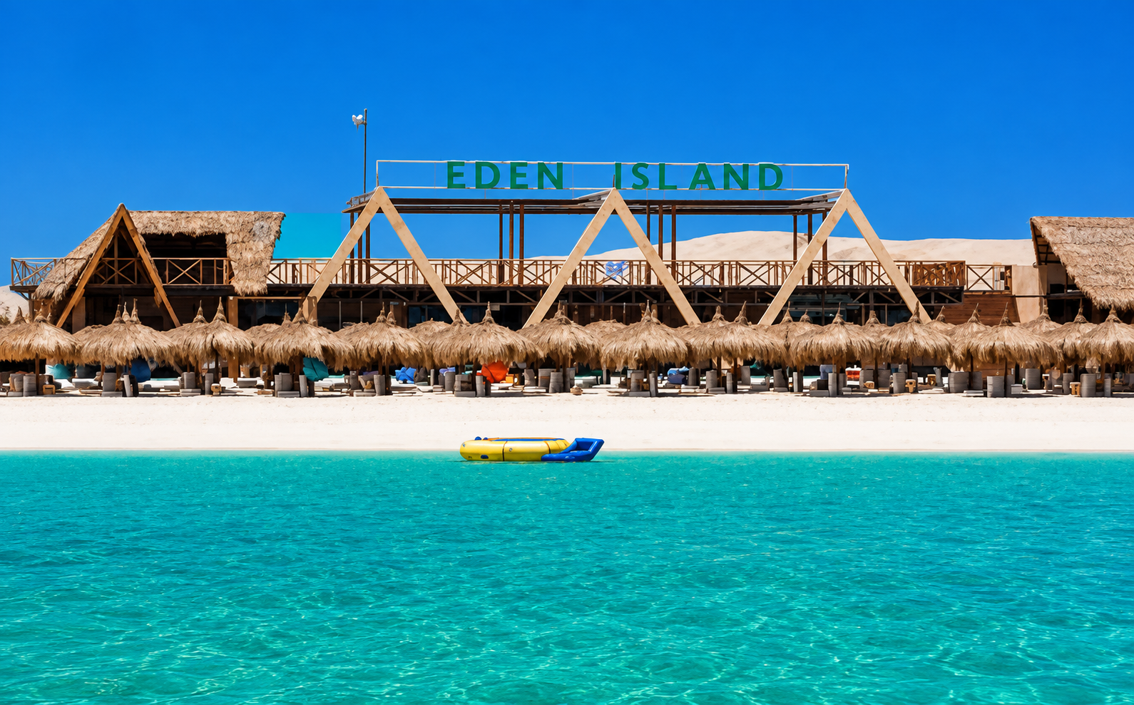Eden beach in Hurghada with white sand, thatched sunshades and clear turquoise water