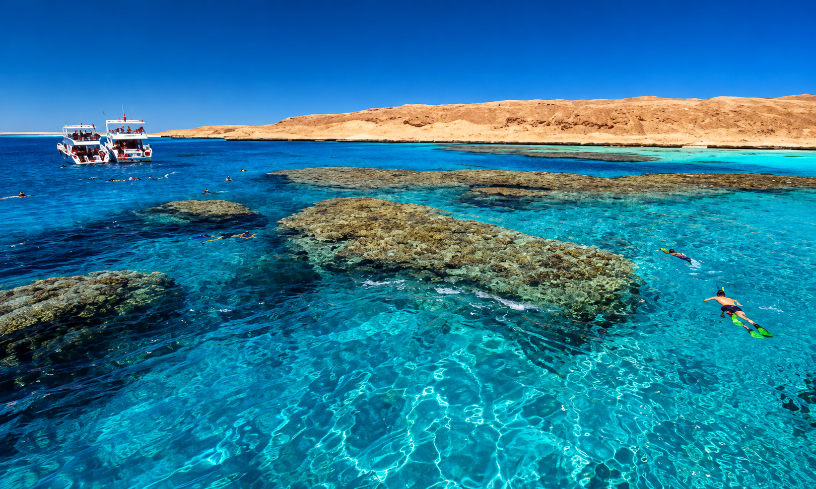 Crystal-clear turquoise water and vibrant coral reefs surrounding Giftun Island in the Red Sea near Hurghada