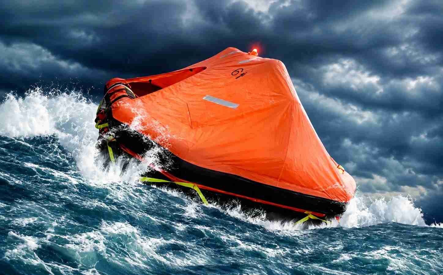 Fully deployed inflatable life raft floating at sea