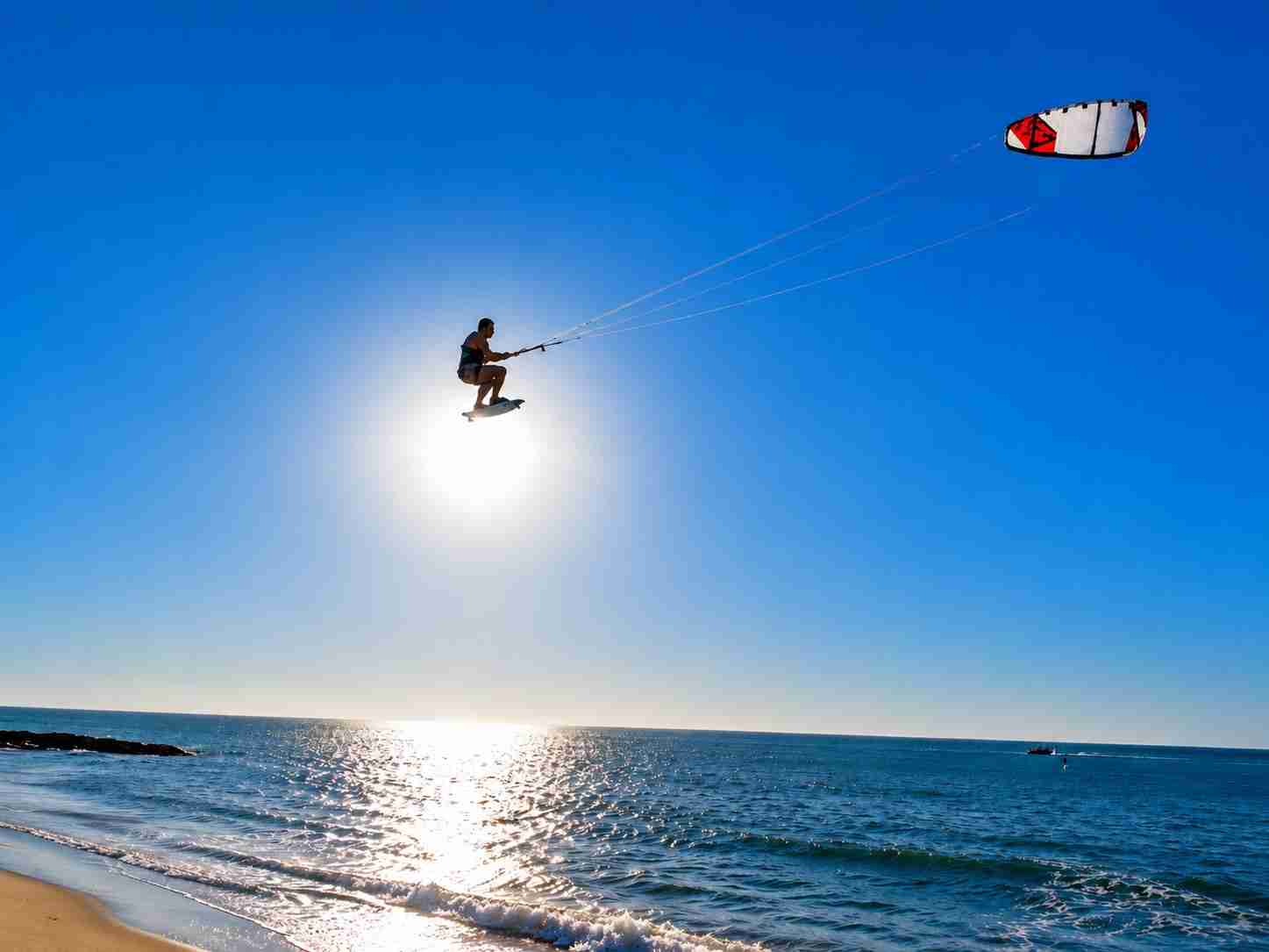 Kitesurfer soaring high during a big-air jump