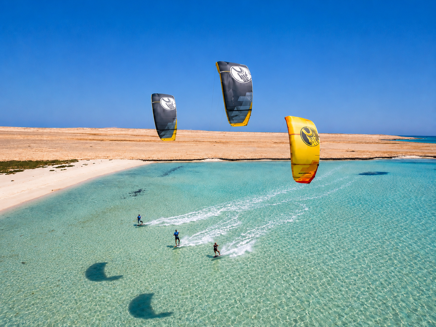 Kitesurfers riding a shallow turquoise lagoon with wide open space