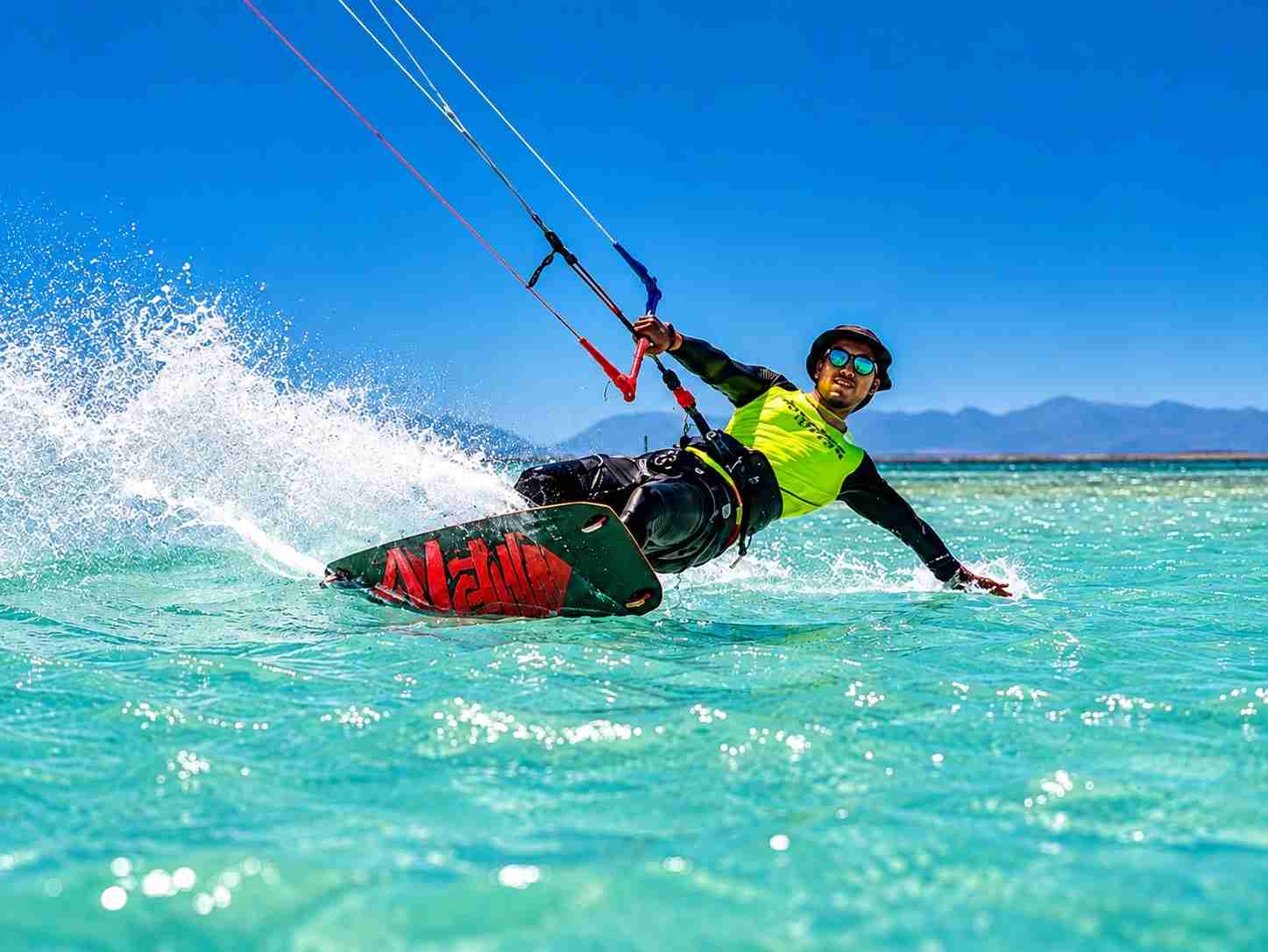 Kitesurfer carving with speed, control and powerful spray