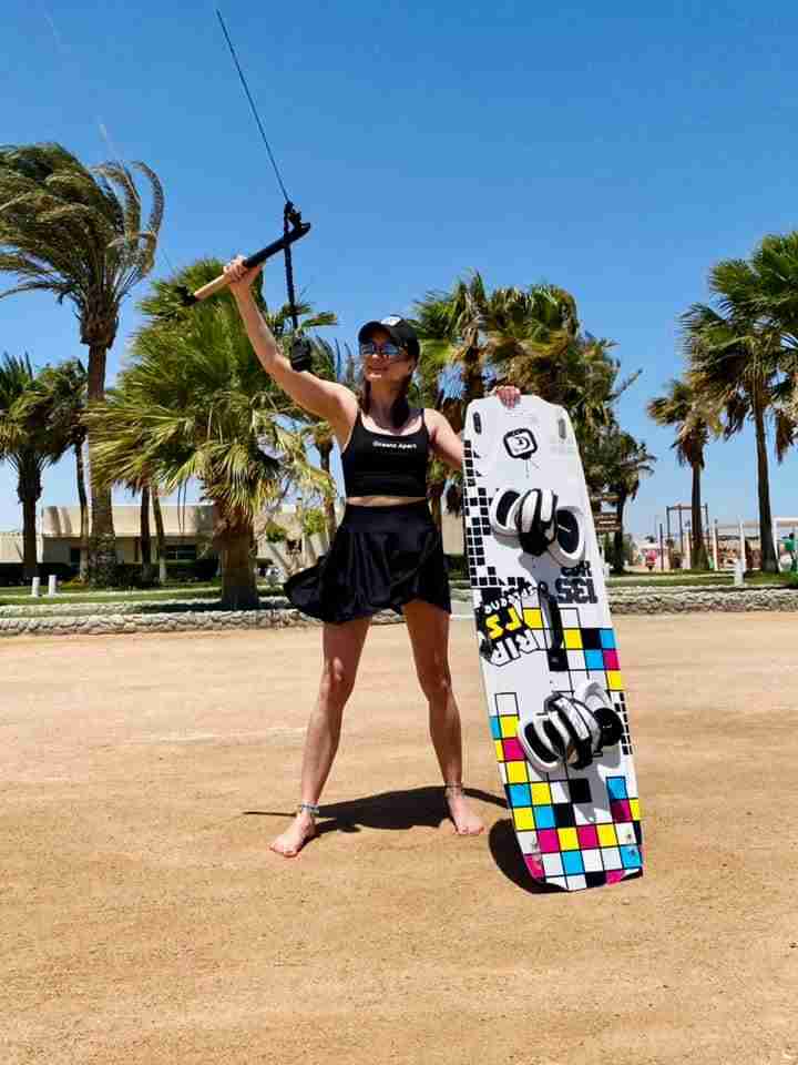 Kitesurfer ready for the wind with board and control bar