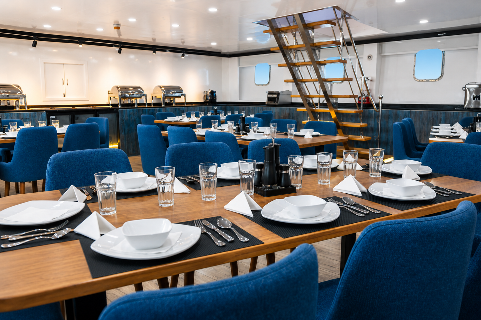 Air-conditioned restaurant laid for dinner on board