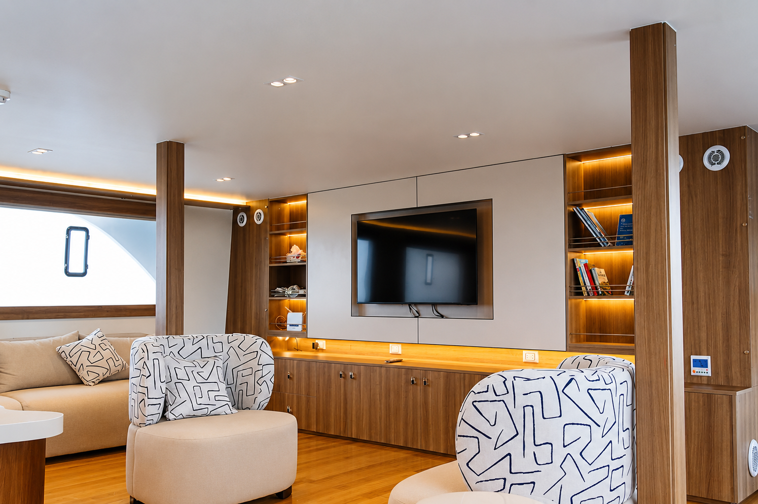 Air-conditioned salon aboard the Ramadan 3 liveaboard with sofas and a screen