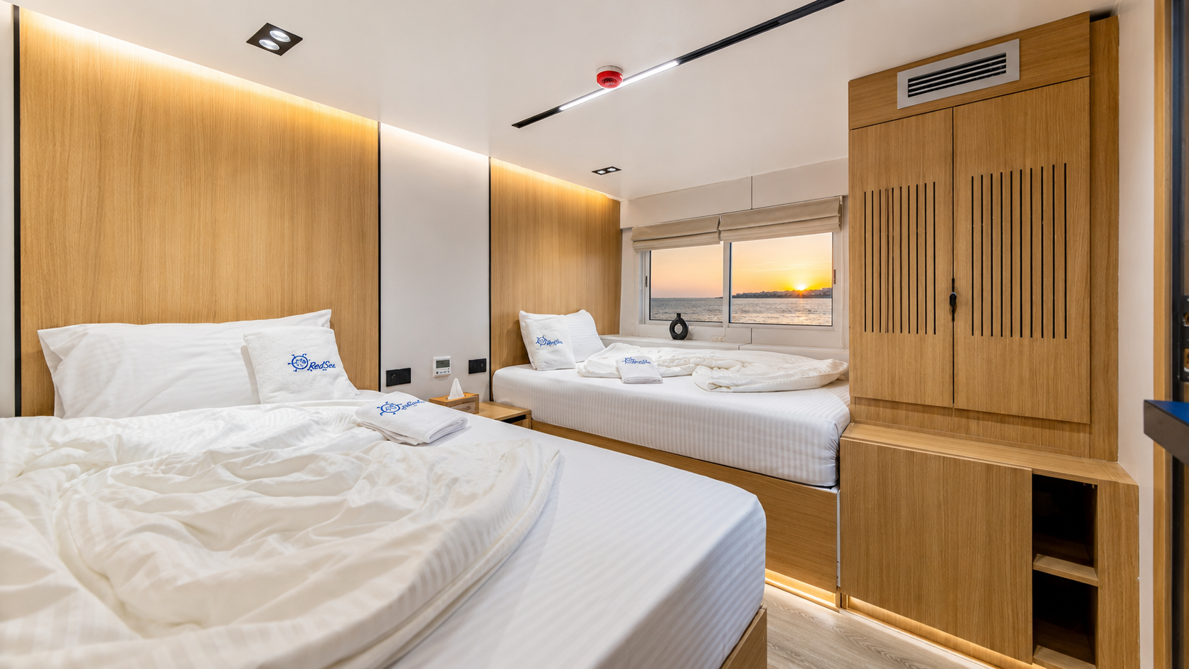 Suite cabin with a double bed and warm wood panelling