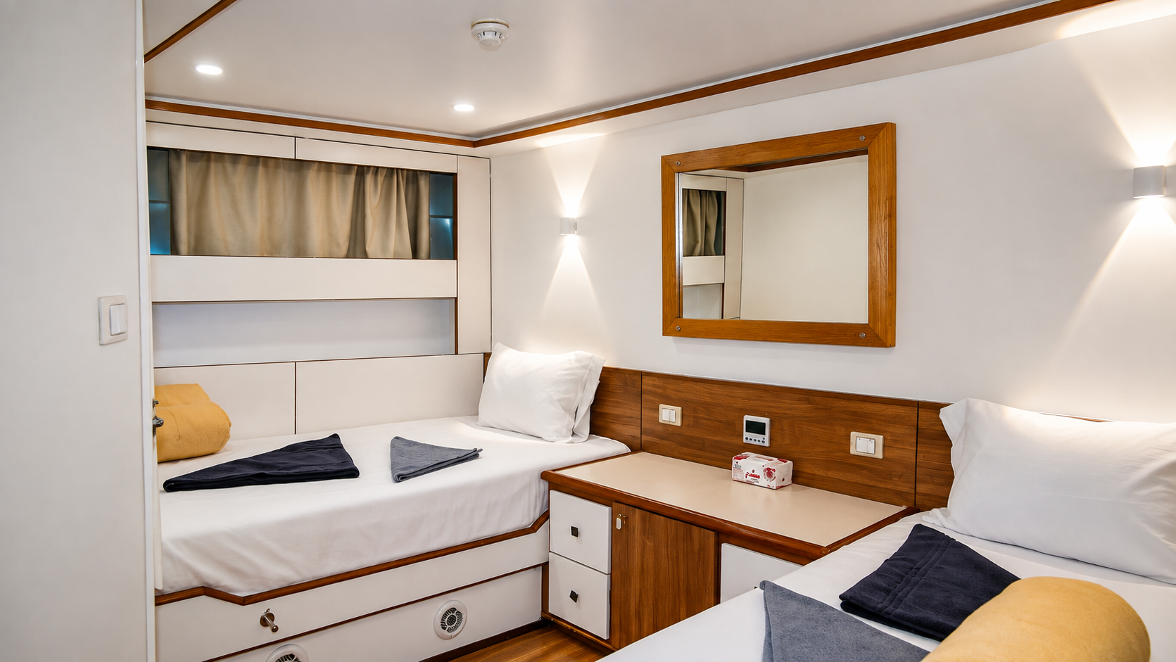 Twin cabin with two single beds and warm wood detailing