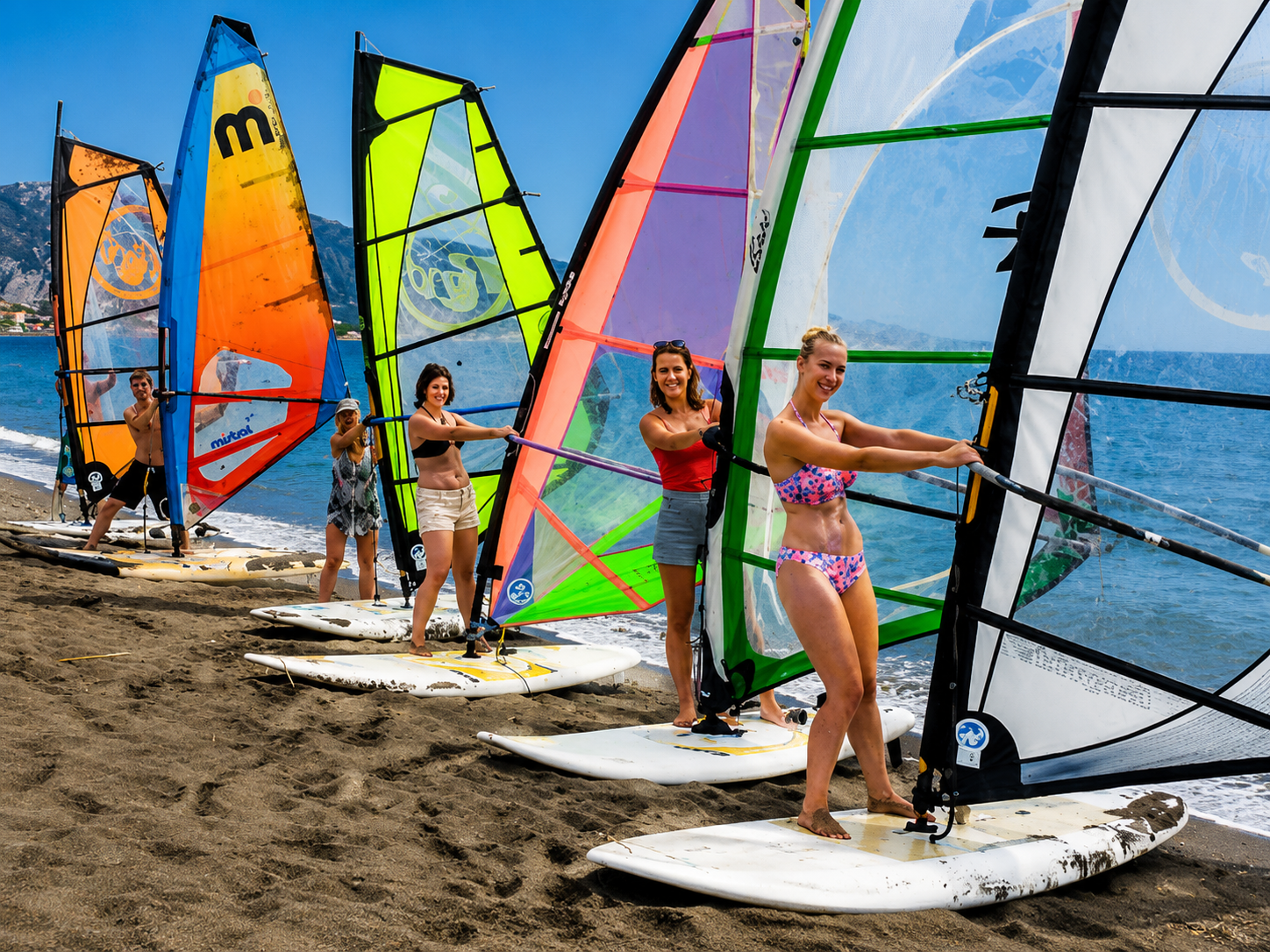 Beginner windsurfing lessons in Hurghada practising sail control on the beach