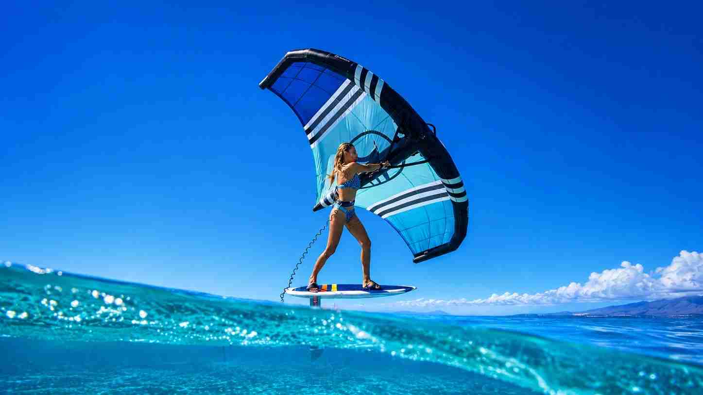 Wing foiler gliding above clear shallow water in Egypt