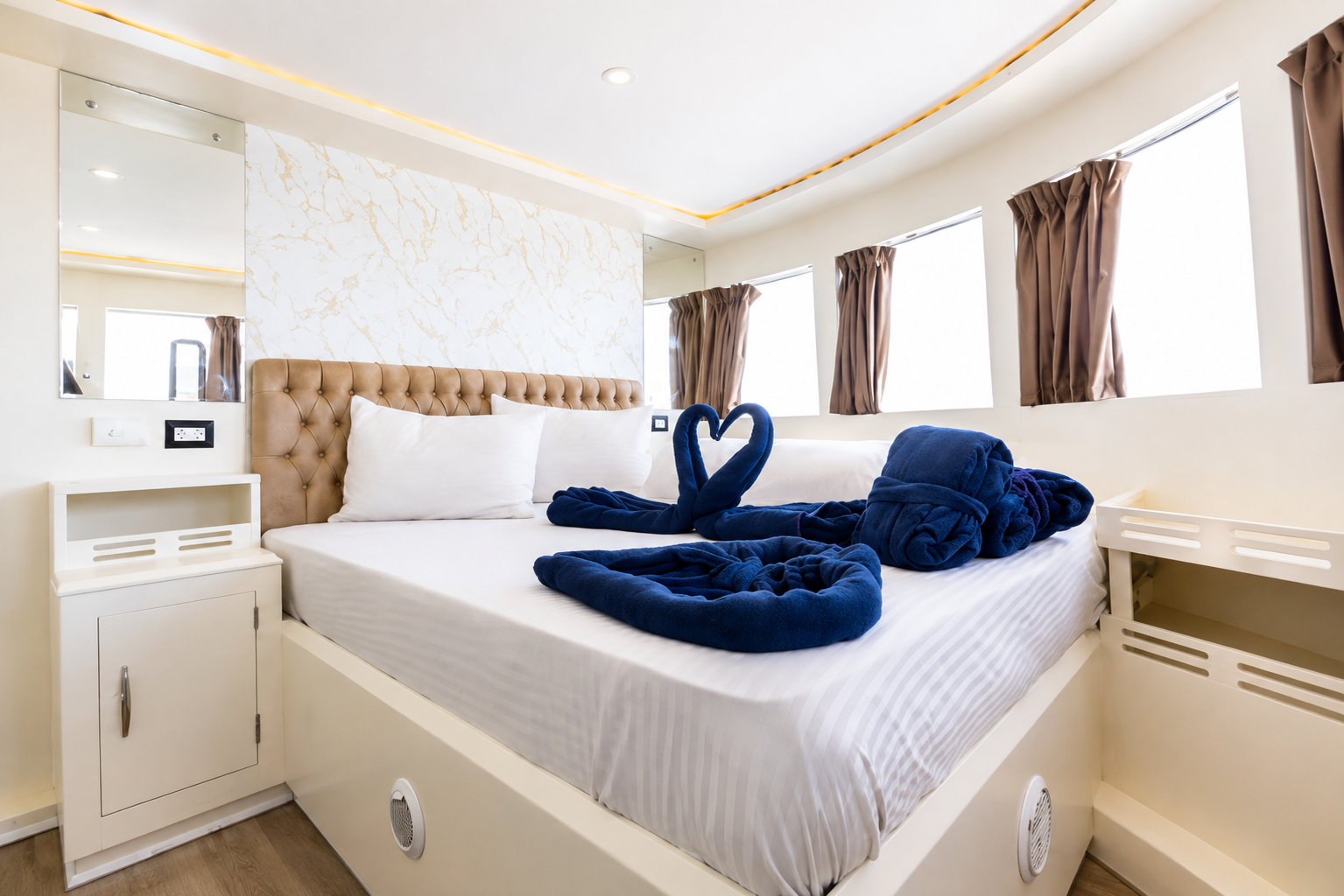 Sun deck cabin with a double bed and warm lighting
