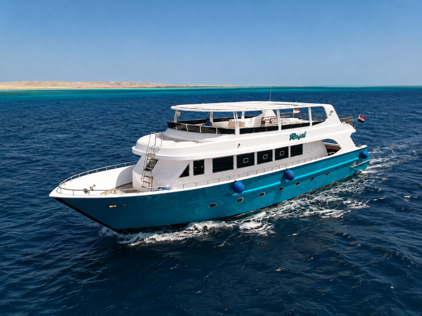 Daily dive boat cruising across clear blue Red Sea water near Hurghada