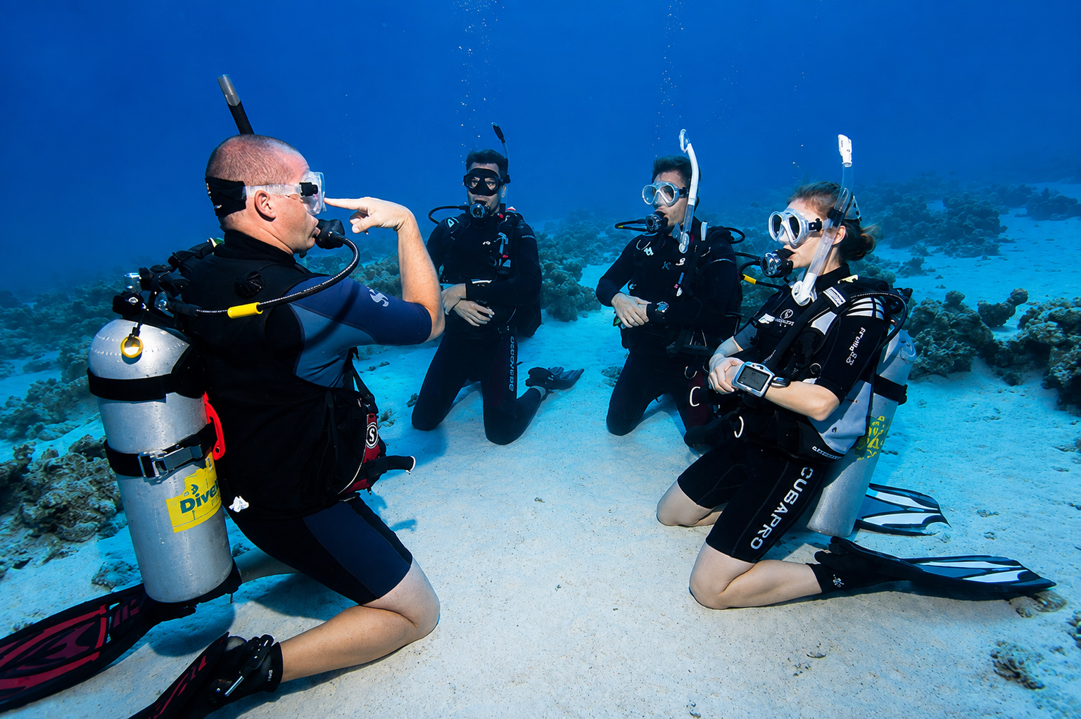 Students practicing mask clearing with an instructor