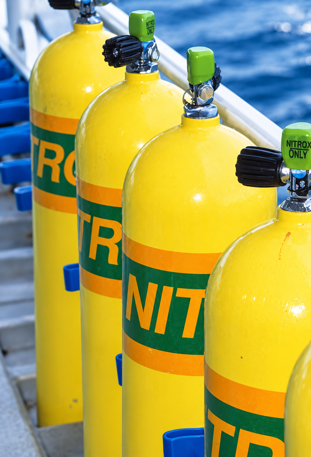 Yellow and green cylinders stacked on the boat