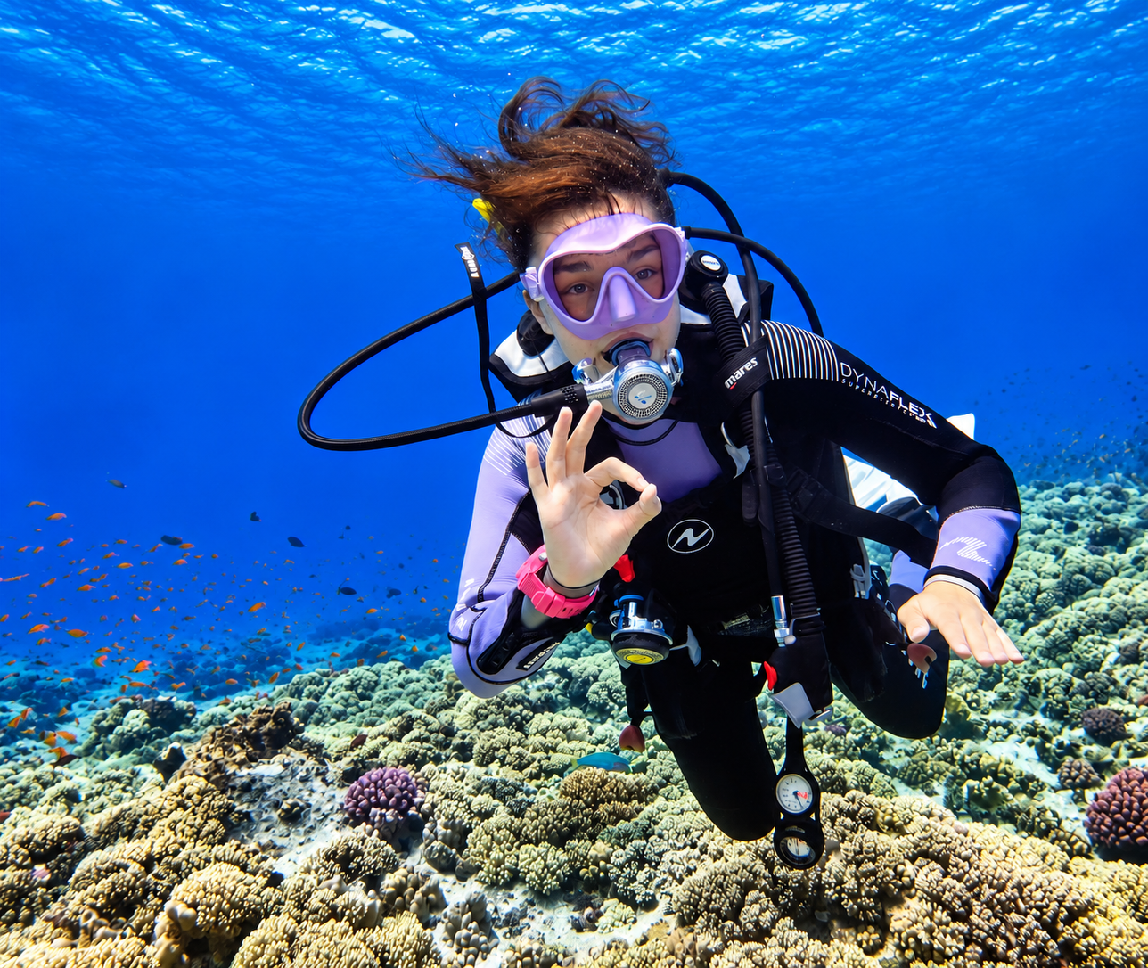 Hand signal used underwater beside a Red Sea coral reef