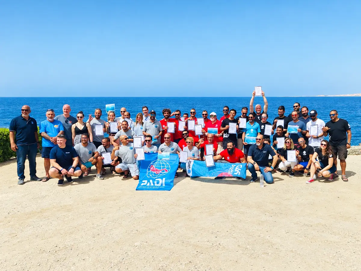Group of divers celebrating certification on the beach