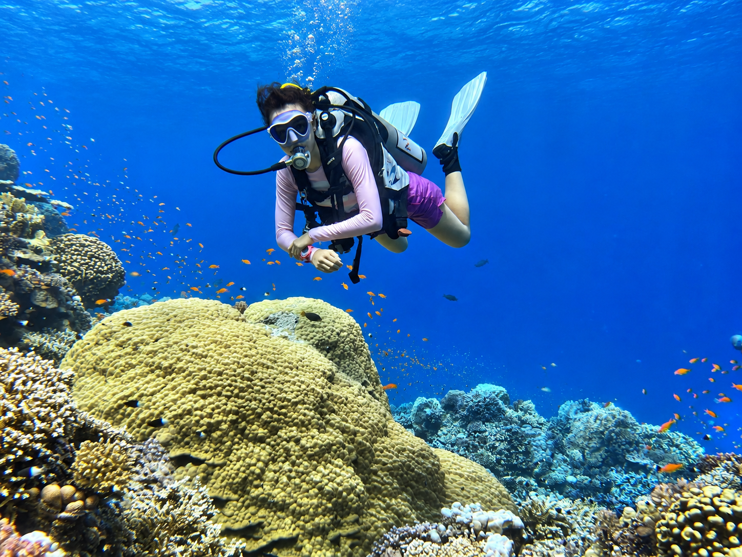Young diver exploring a coral reef on the PADI Junior Open Water course in Hurghada