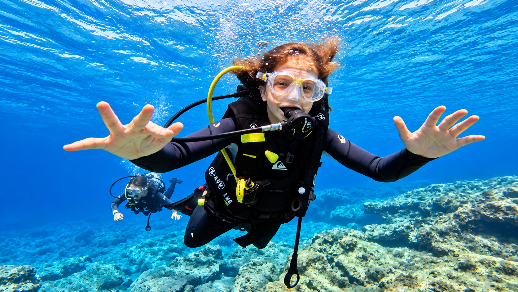 Junior Open Water student swimming over the reef in Hurghada