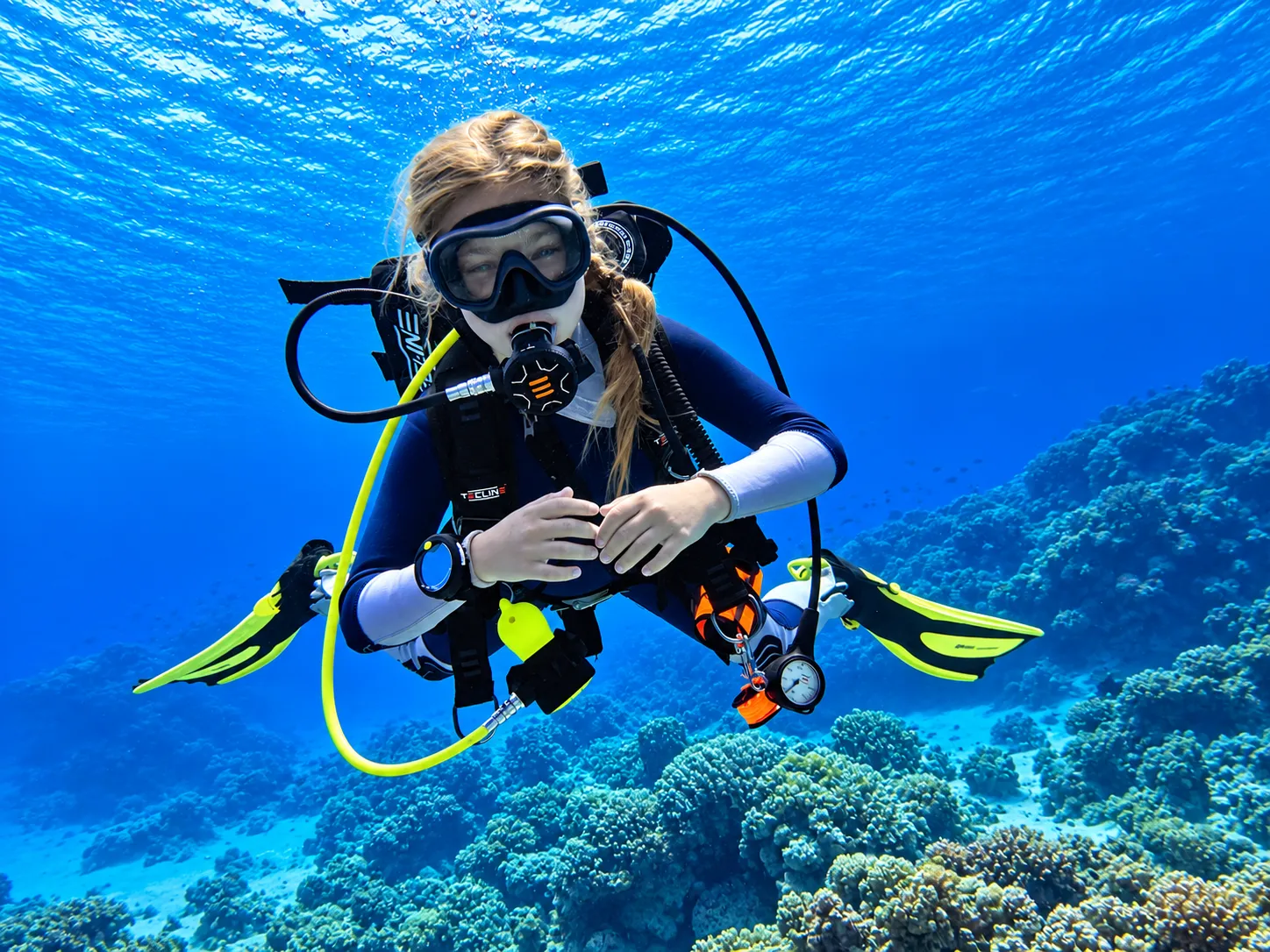 Guest practicing basic underwater control with an instructor
