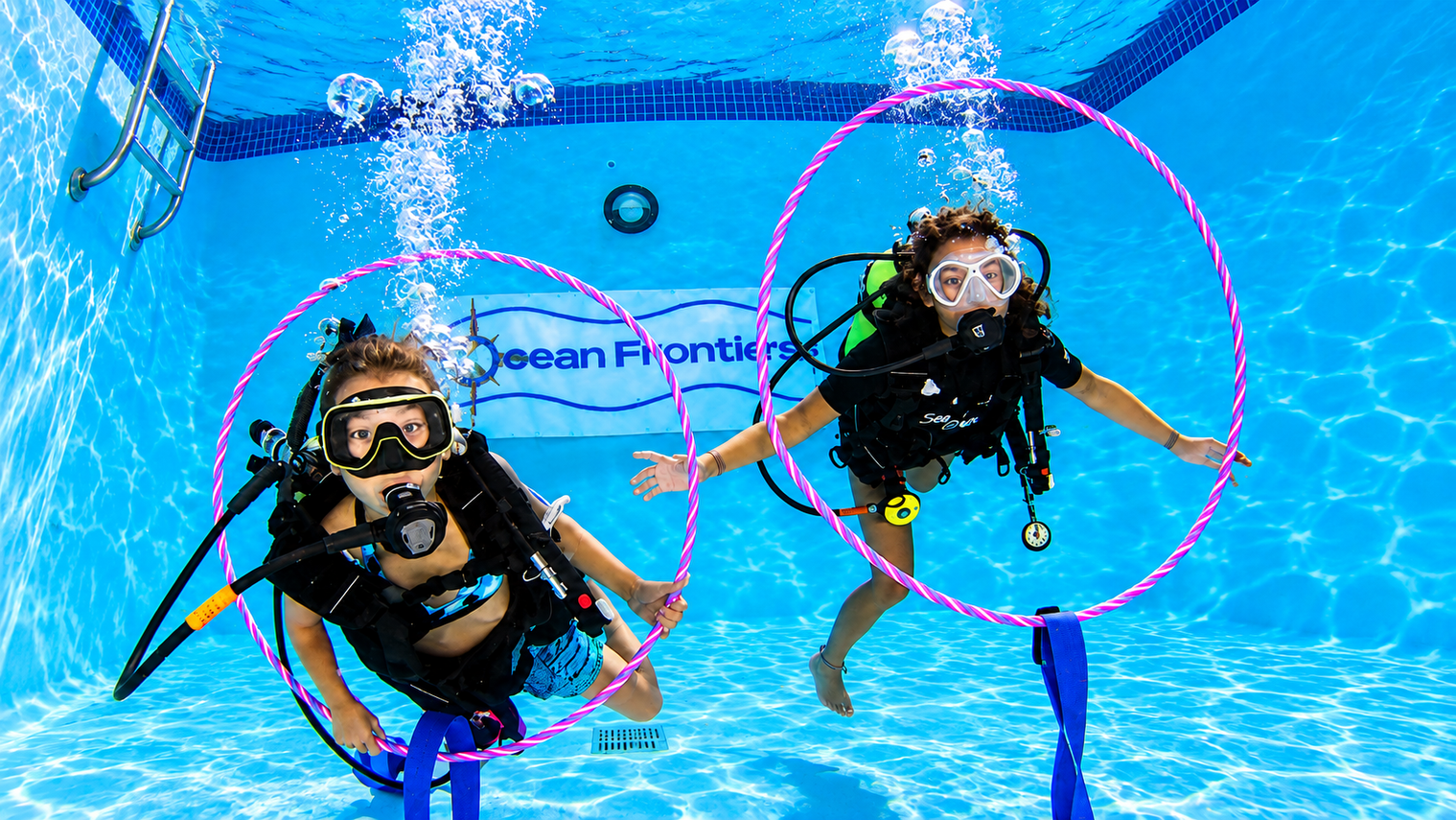 Child swimming through an underwater obstacle course in the pool