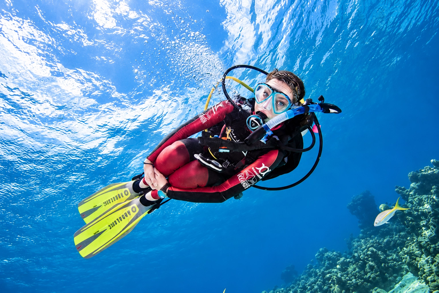 Diver in trim above a shallow coral garden