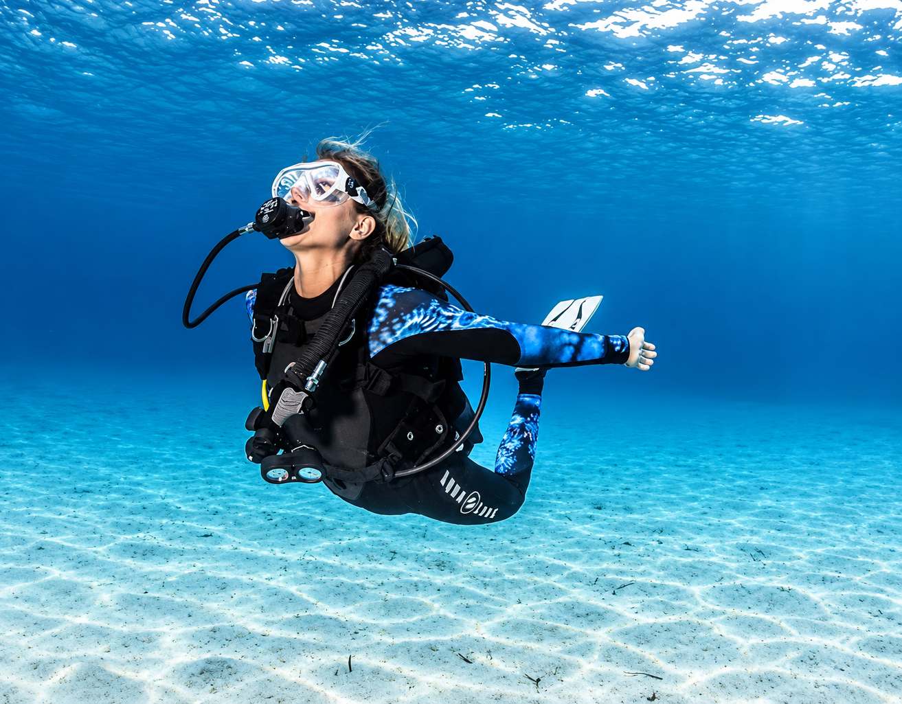 PADI Peak Performance Buoyancy student holding position over a Red Sea reef