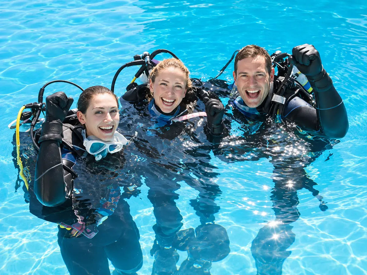 PADI MSDT Specialty Instructor group in the pool signaling OK