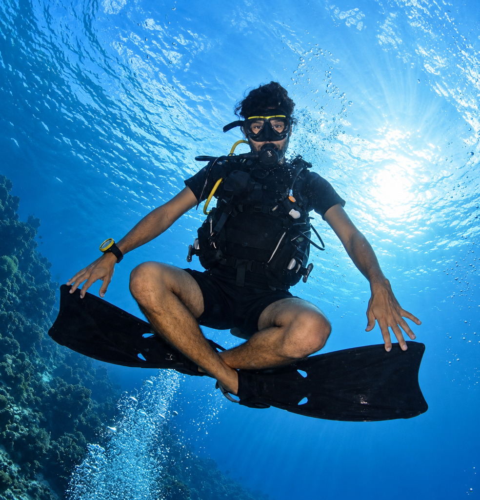 Diver sitting cross-legged in midwater