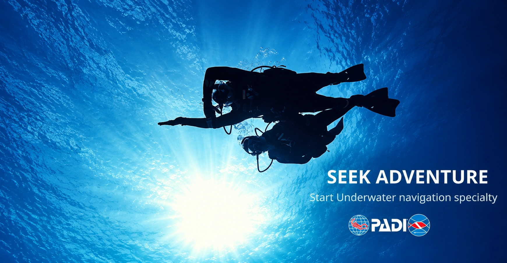 Diver silhouetted against the sunlight while holding a heading